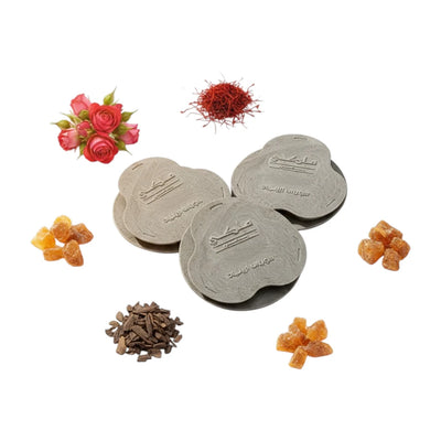 Malaki Bakhoor - 18 premium tablets placed with floral, spice, and fruit decorations on a white background