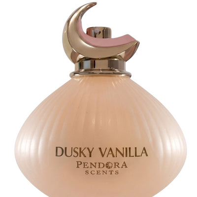 Palette 21 Dusky Vanilla Eau de Parfum in a ribbed peach glass bottle with a gold crescent moon cap.