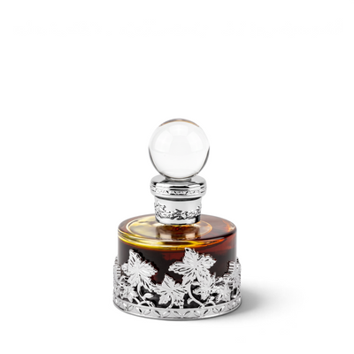 Palette 21 Mukhalat Malaki 207 25ml perfume oil in a round amber glass bottle with ornate silver floral filigree