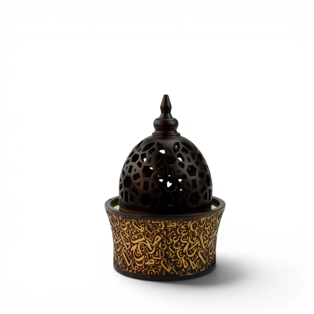 Decorative  Black Bakhoor Burner with intricate design on a white background