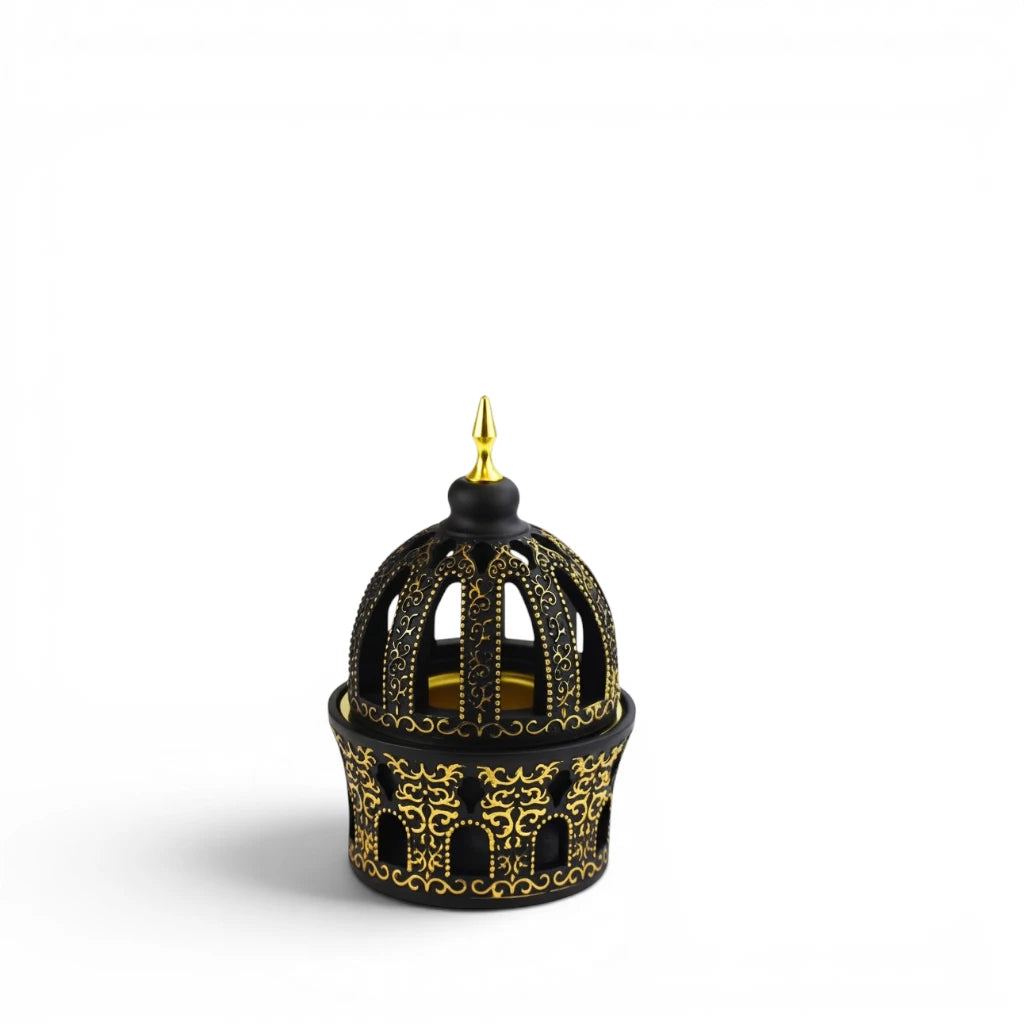 Decorative Black and Gold Bakhoor Burner with a pointed top on a white background