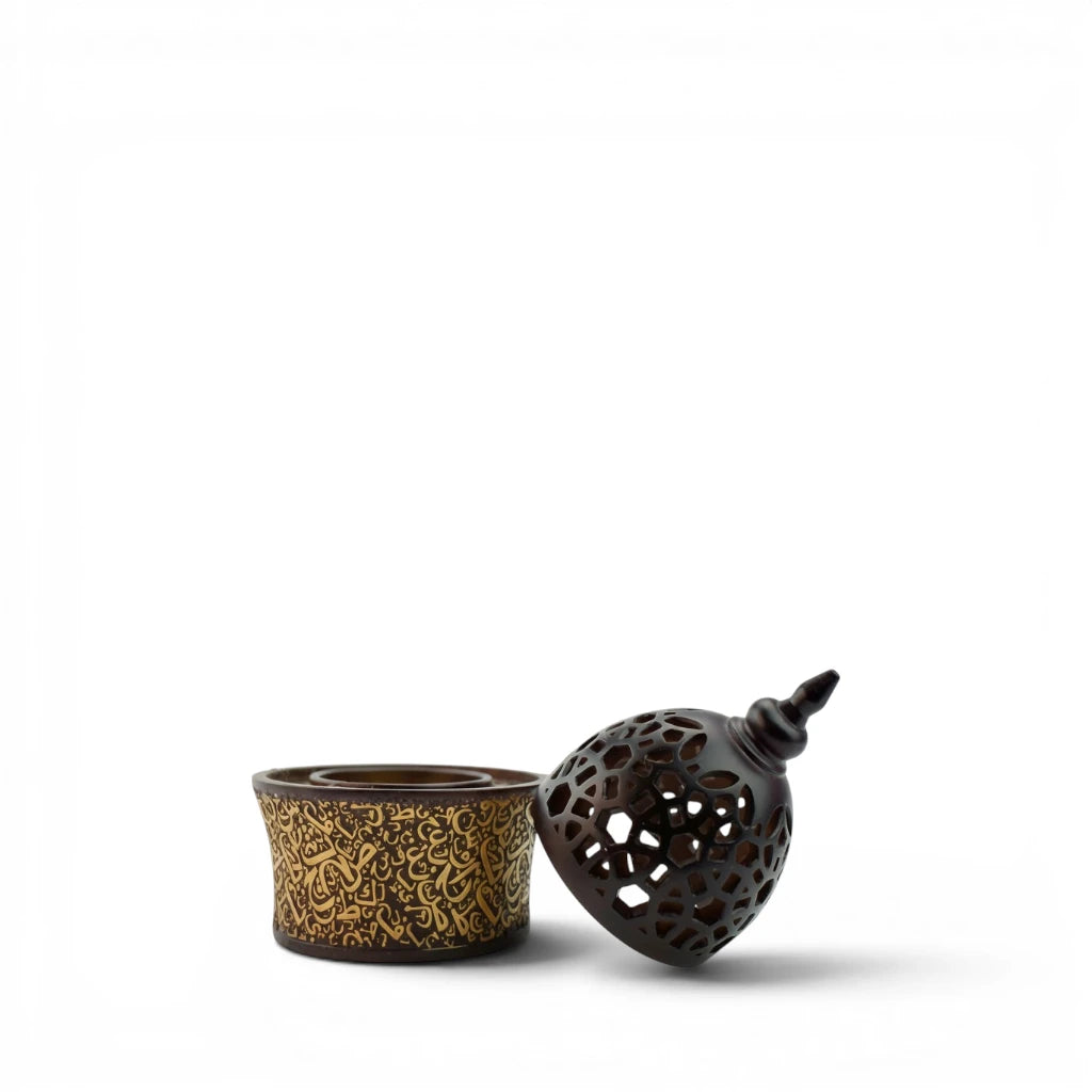 Two Calligraphy Style Closed Brown Bakhoor Burner parts , one with intricate gold patterns and the other with a textured black design, on a white background.