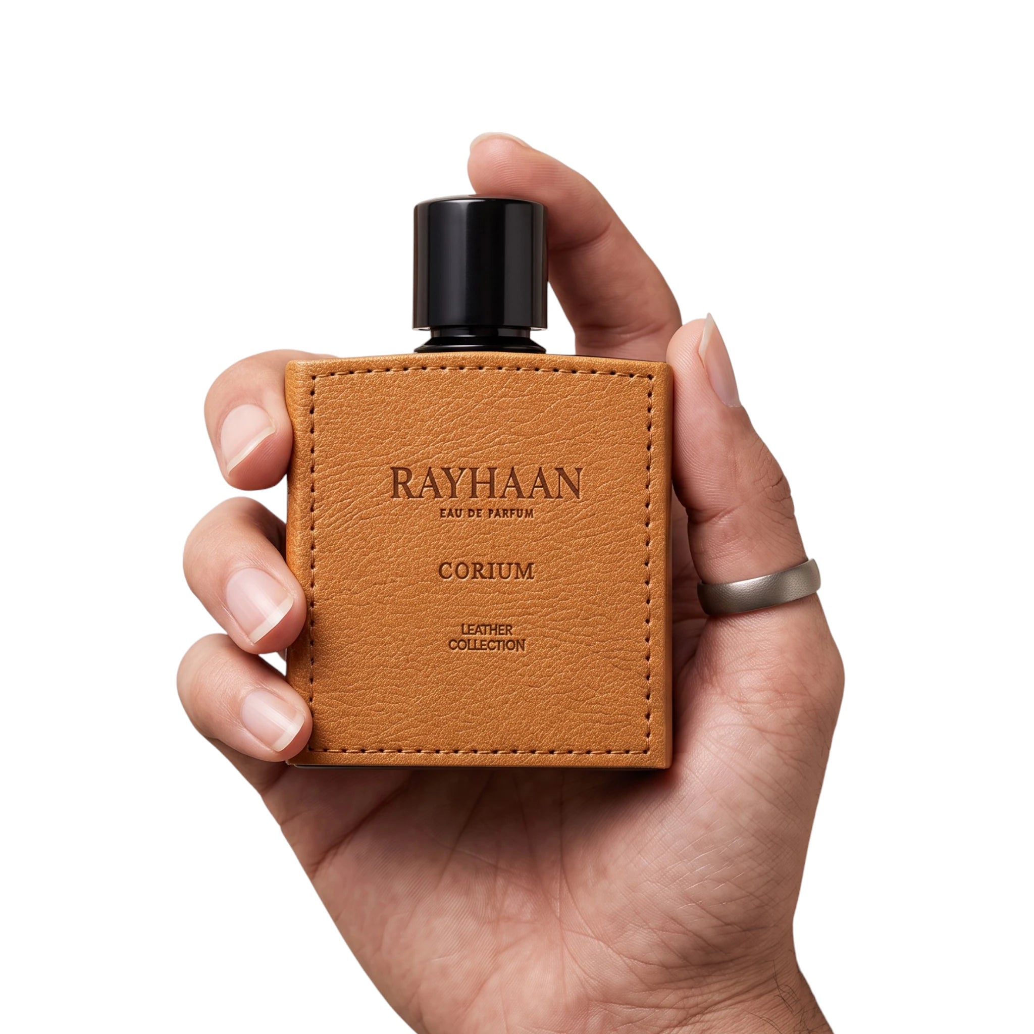 Hand holding Corium by Rayhaan leather oud cologne bottle