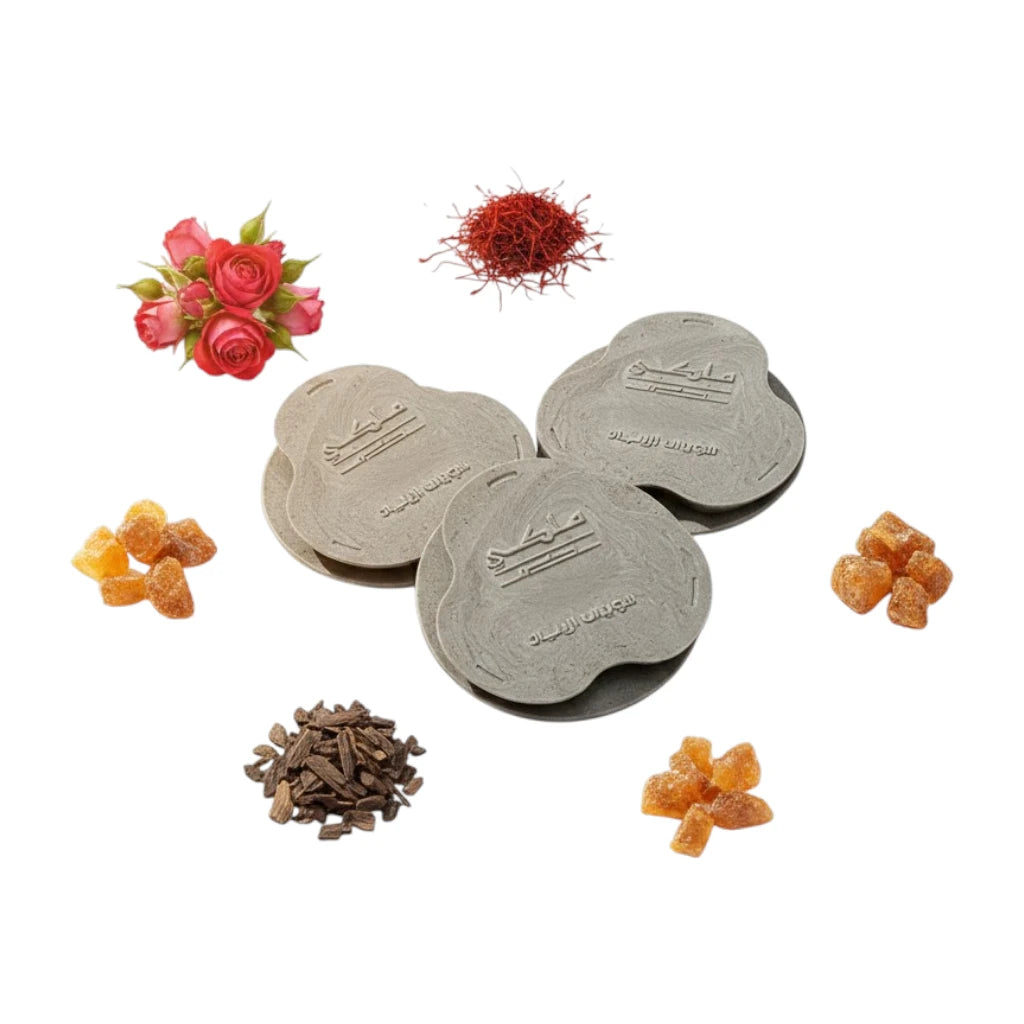 Malaki Bakhoor - 18 premium tablets placed with floral, spice, and fruit decorations on a white background