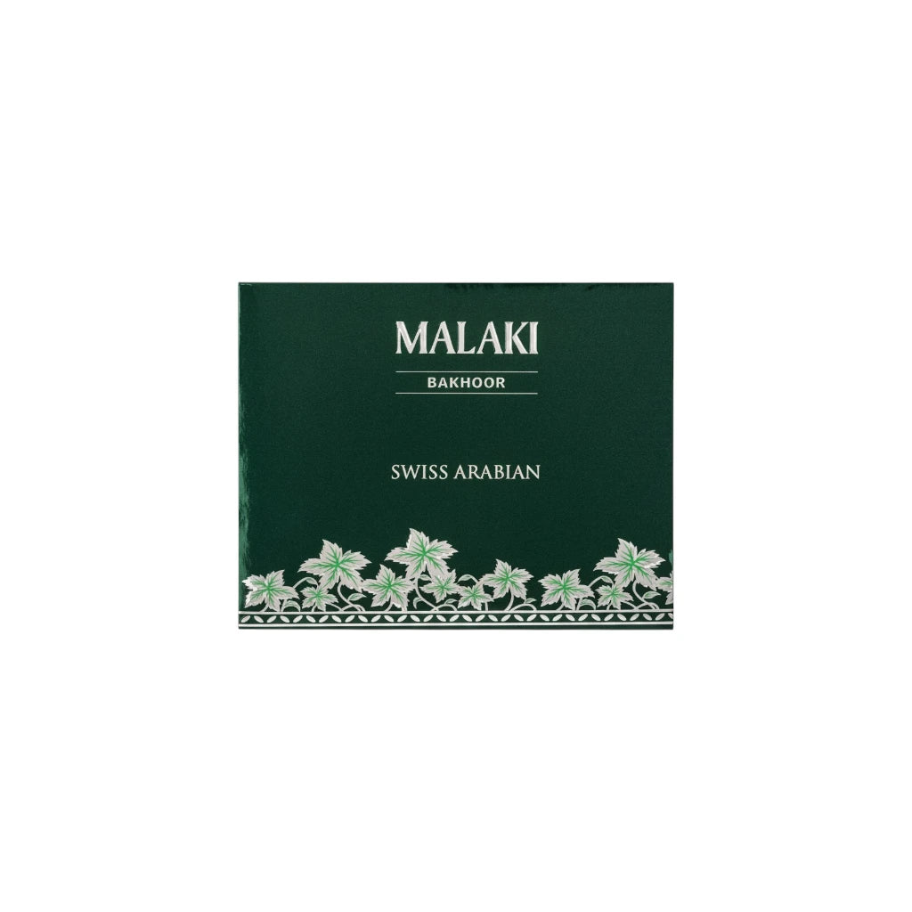 Green packaging of Swiss Arabian Malaki Bakhoor tablets with decorative elements on a white background