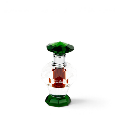 Palette 21 Dehn El Oud Cambodi perfume oil in a decorative clear and green crystal bottle with a silver cap