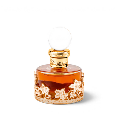 Palette 21 Oud Malaki 25ml concentrated perfume oil in a round glass bottle with an ornate gold leaf metal casing