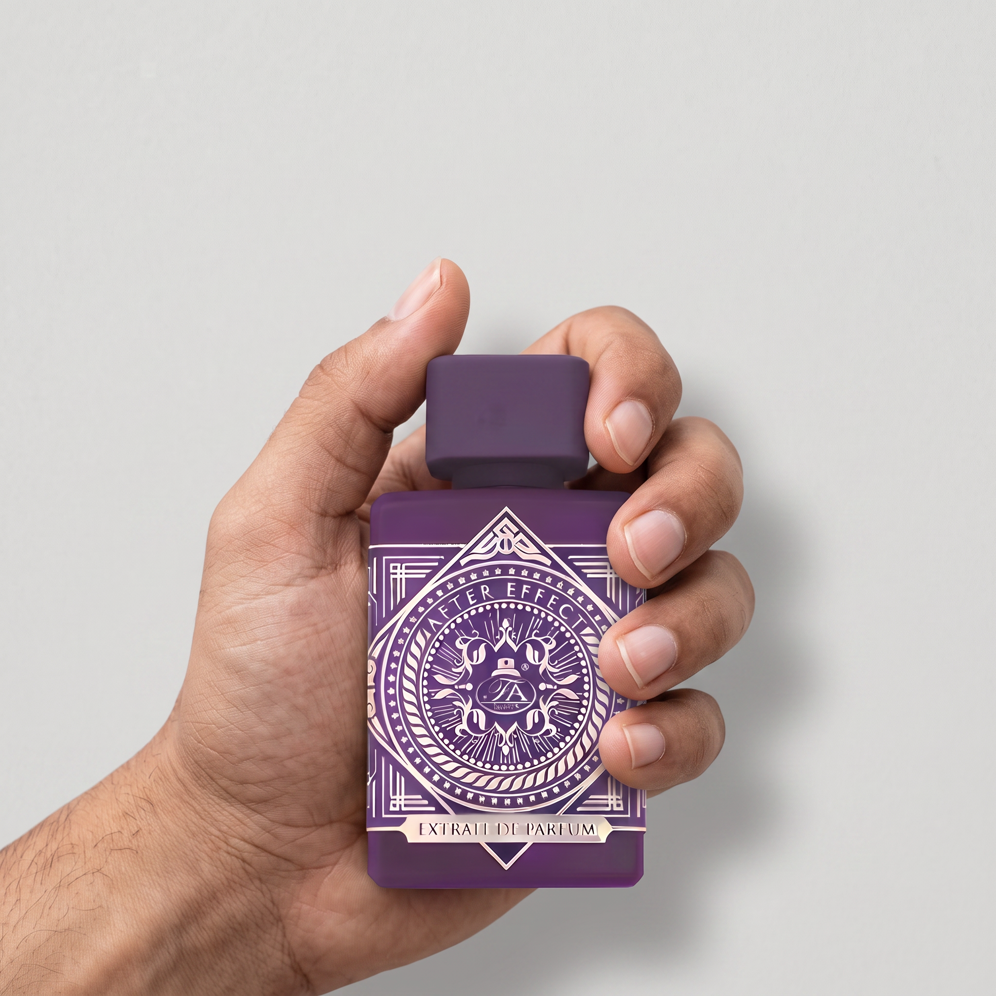 Hand holding a Palette 21 After Effect Extrait De Parfum bottle with deep purple glass and vintage geometric design