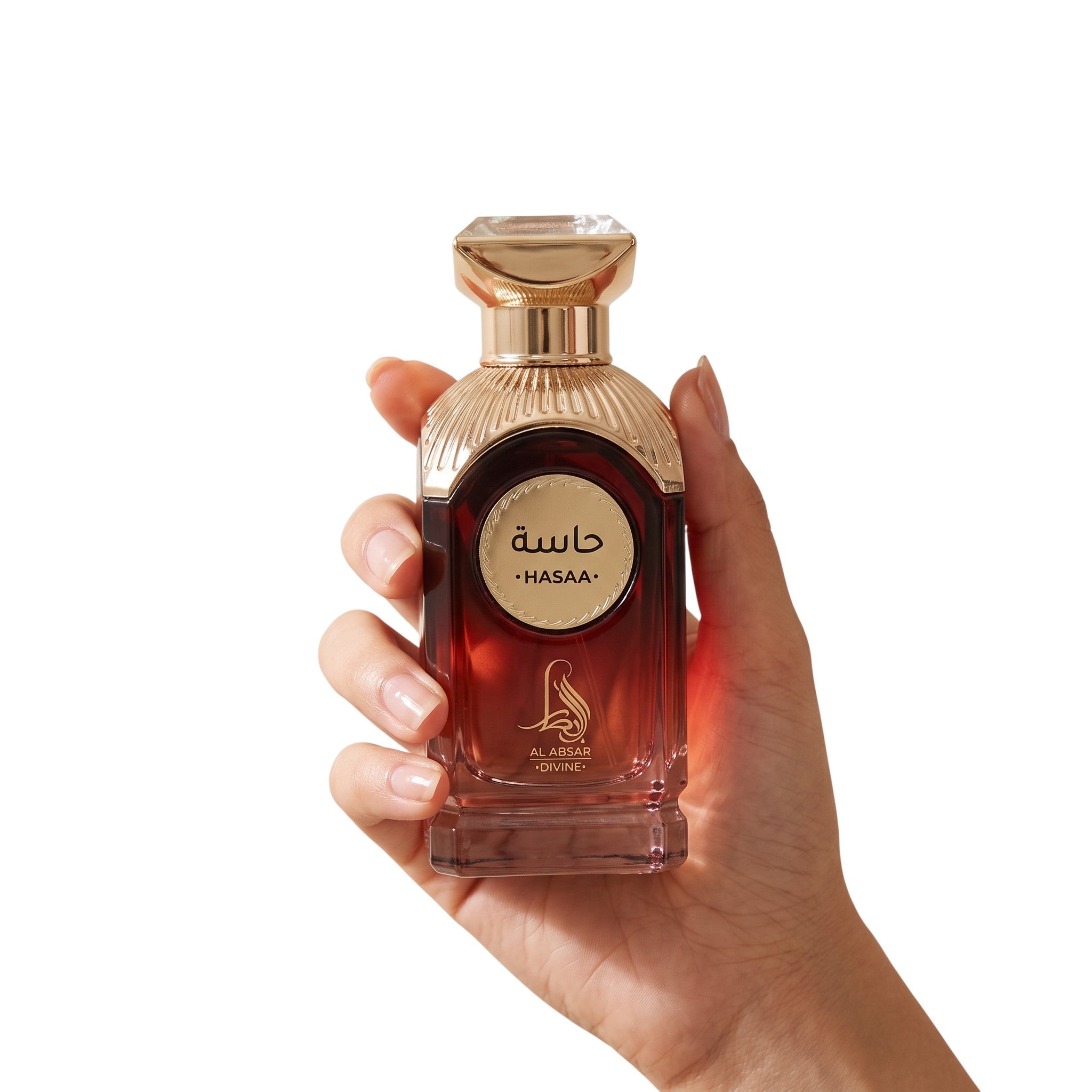 Palette 21 AL ABSAR HASAA Eau de Parfum in a deep red glass bottle with gold accents held in a hand