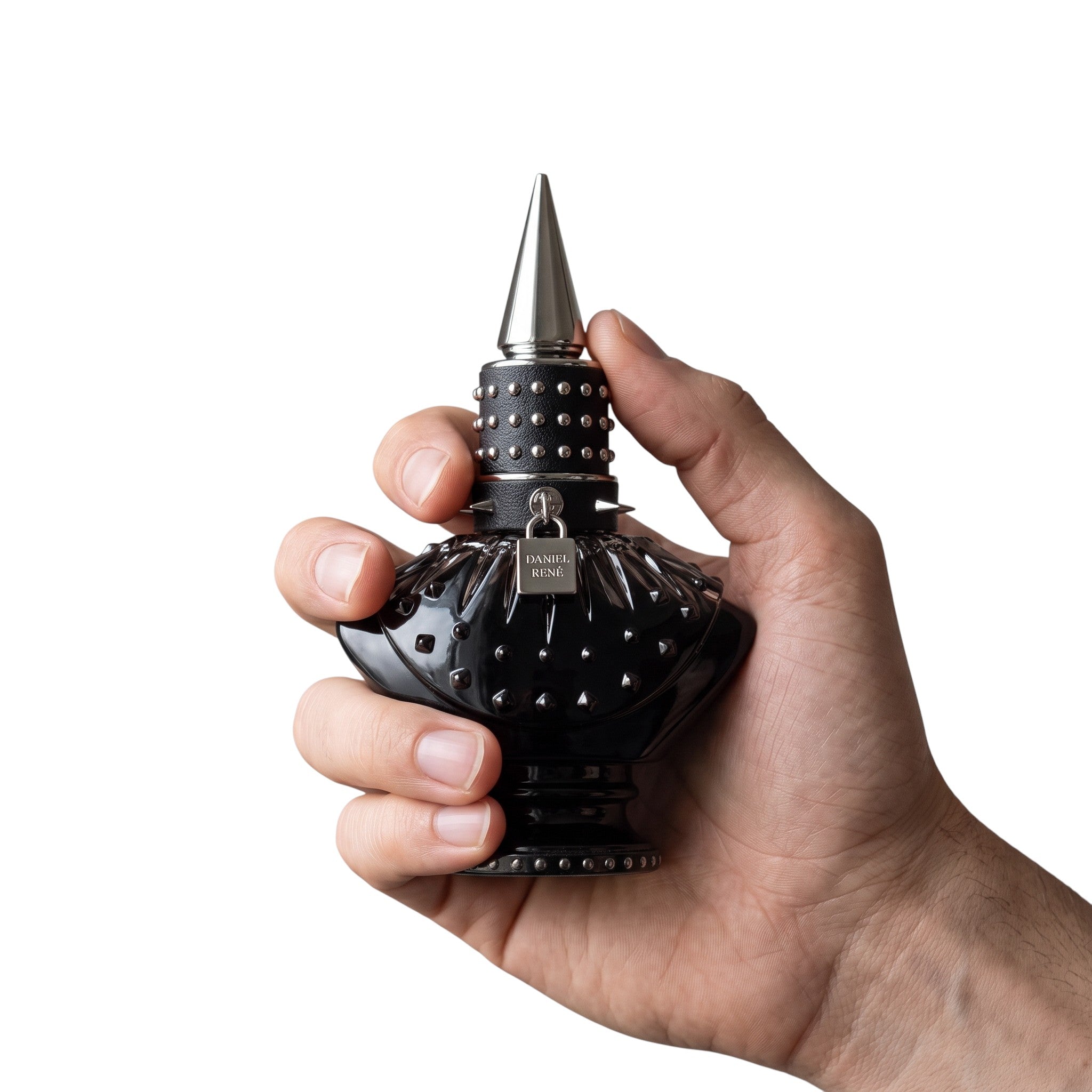 Palette 21 DANIEL RENÉ Midnight Sin perfume bottle in black with metallic studs and a spiked cap held in a hand