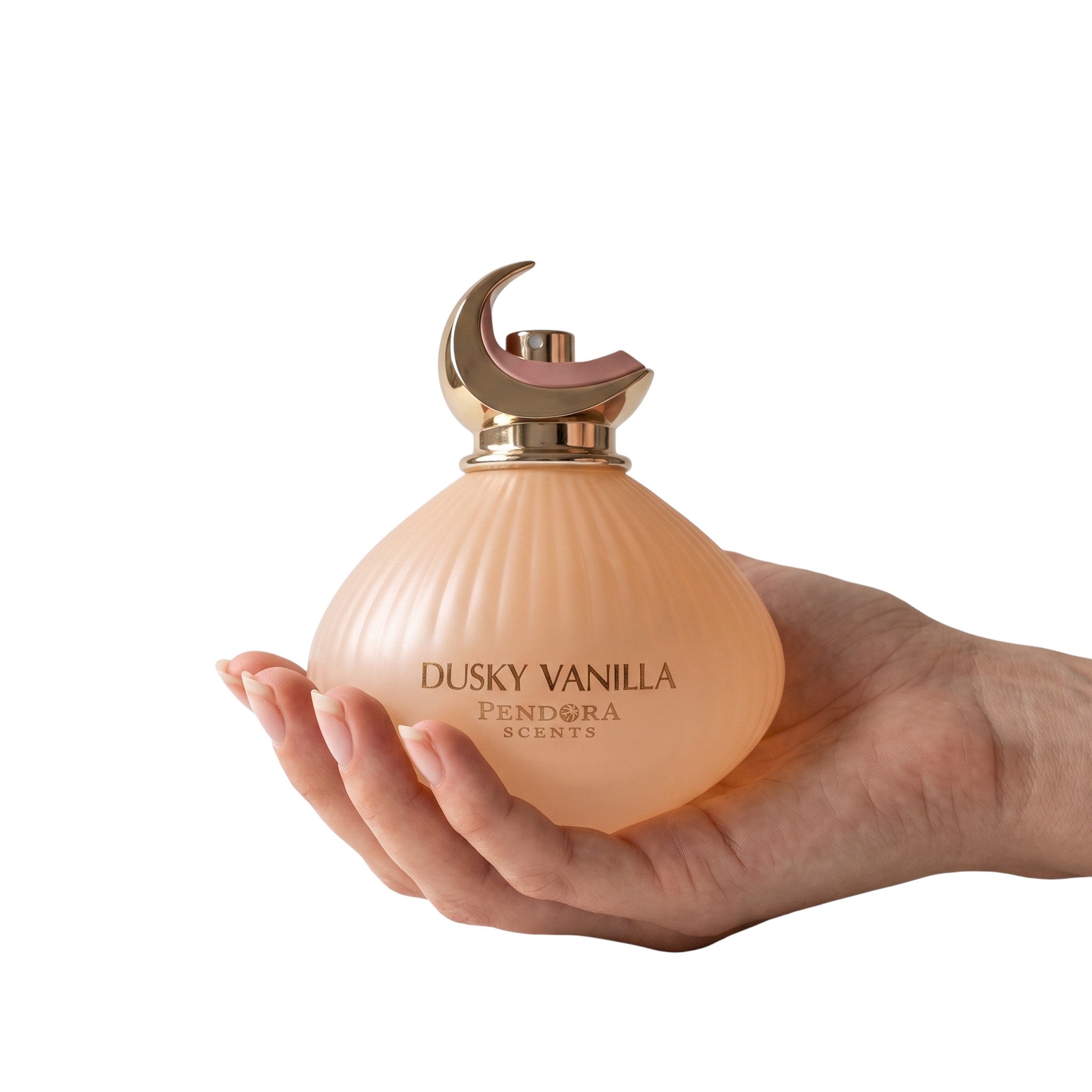 Palette 21 Dusky Vanilla perfume bottle with a crescent moon cap held in a hand against a white background