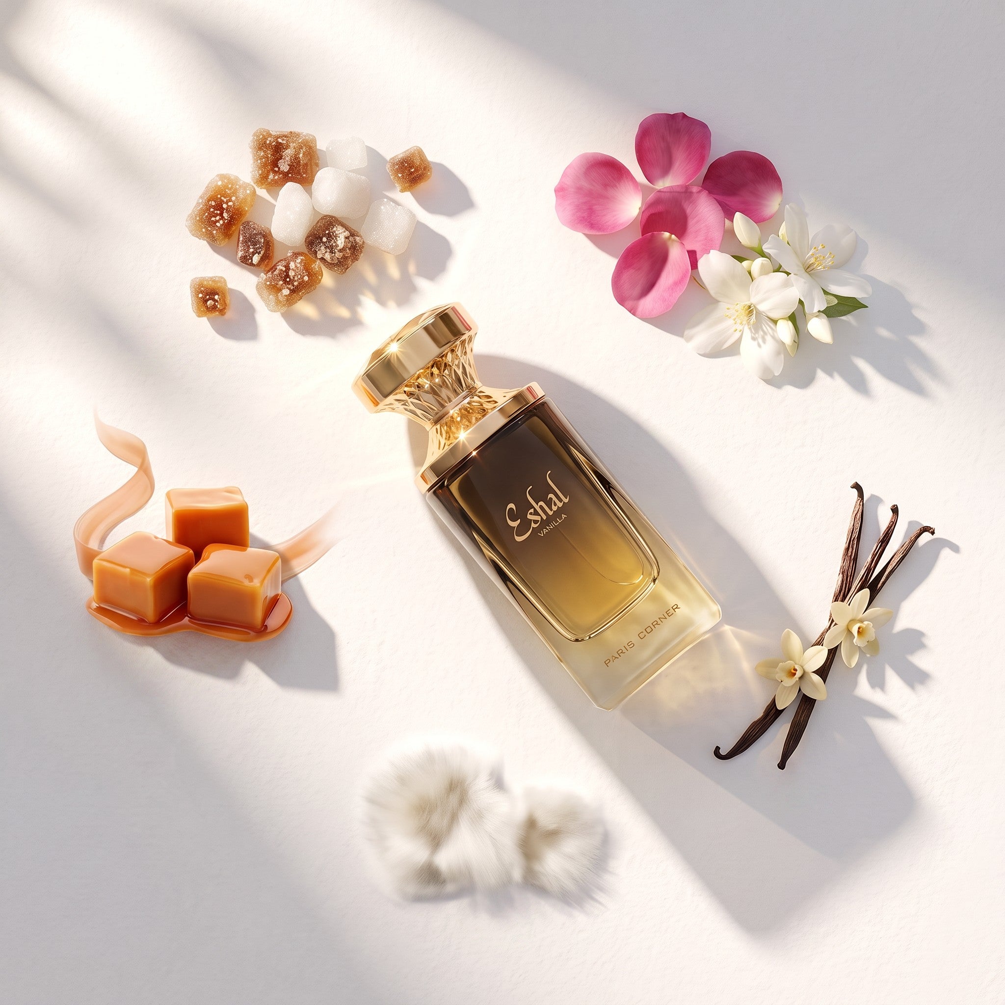 Palette 21 PARIS CORNER Eshal Vanilla perfume bottle surrounded by sugar cubes, rose petals, caramel, and vanilla beans.