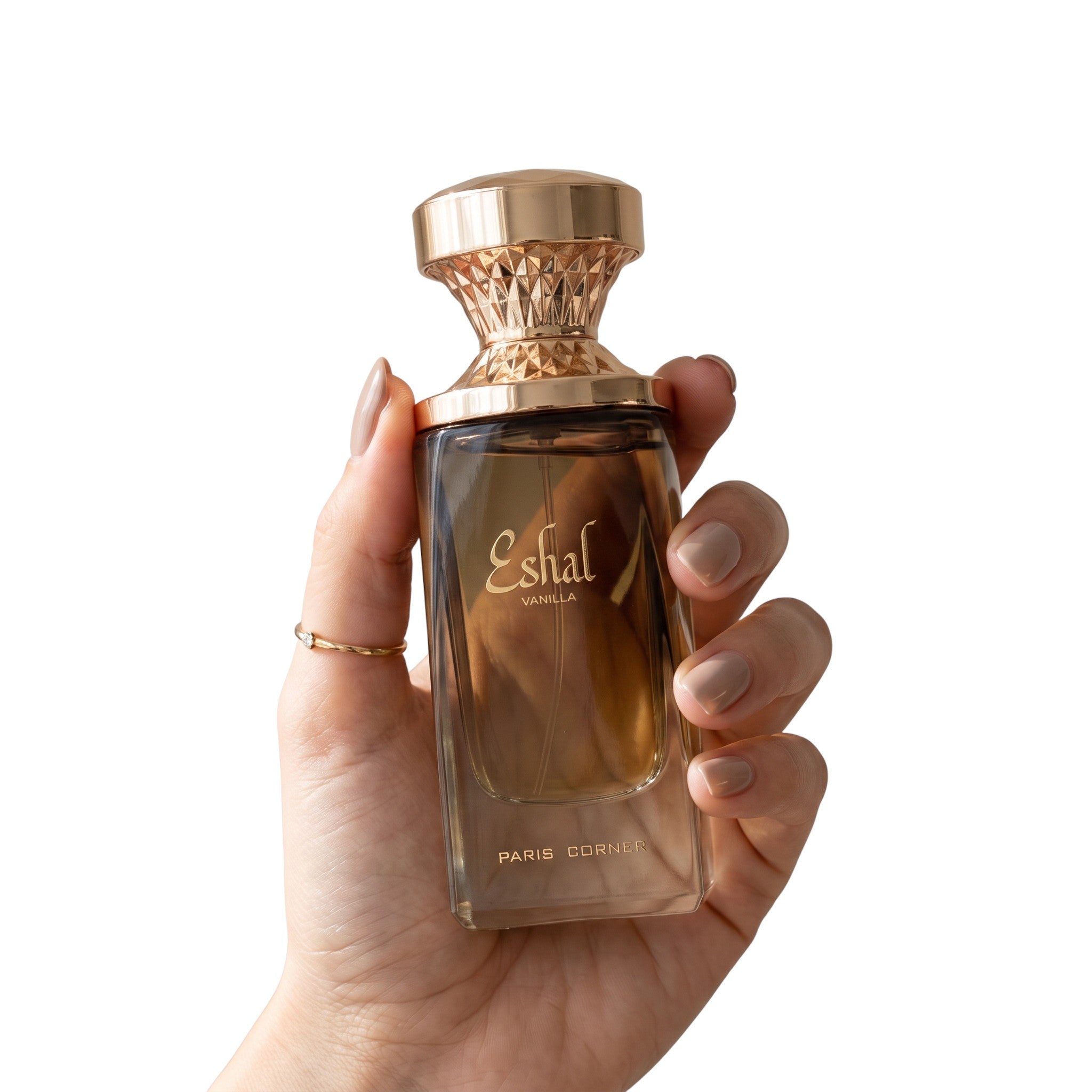 Palette 21 Eshaal vanilla perfume bottle with a gold geometric cap held in a hand against a white background