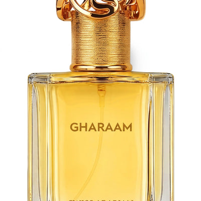 Close-up of Swiss Arabian Gharaam bottle showing the ornate gold cap and engraved glass design