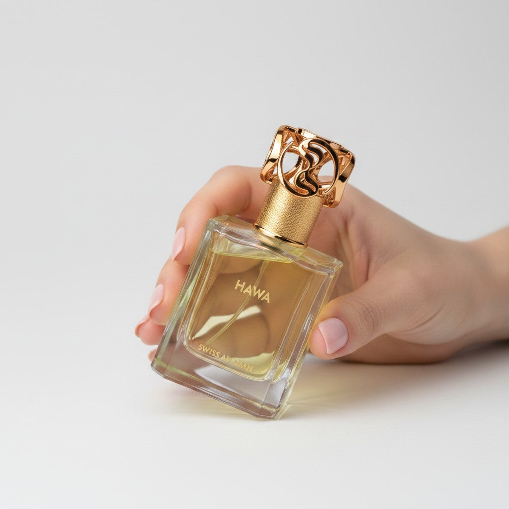 Palette 21 HAWA perfume bottle with a gold ornate cap held in a hand against a clean white background