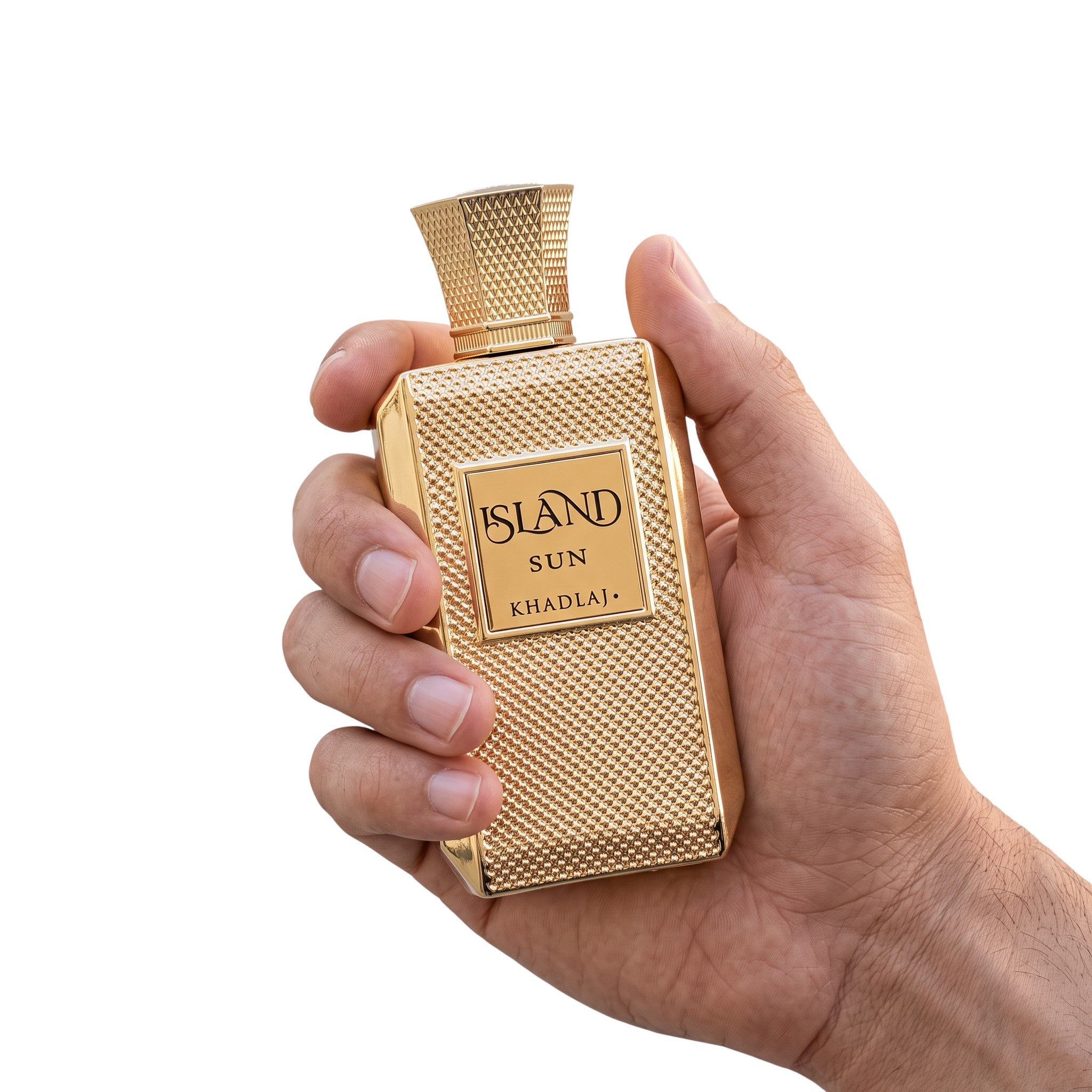 Palette 21 Khadlaj Island Sun eau de parfum in a textured gold bottle held in a hand against a white background
