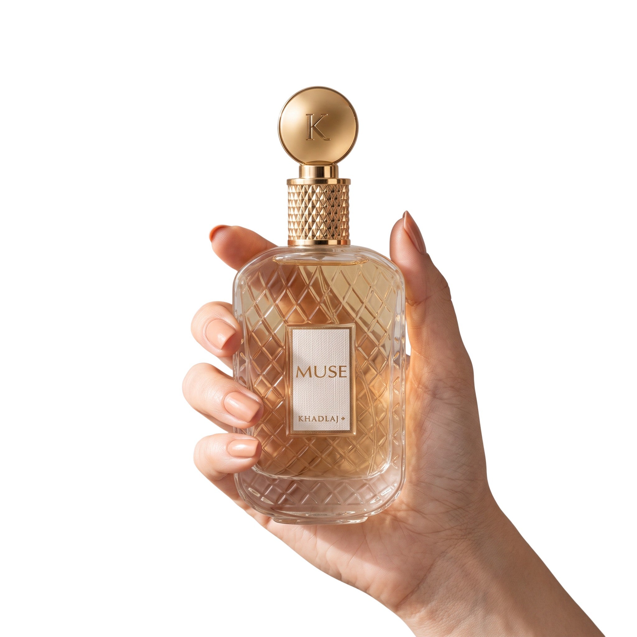 Palette 21 KHADLAJ Muse Eau de Parfum in a textured glass bottle with a gold cap held in a hand.