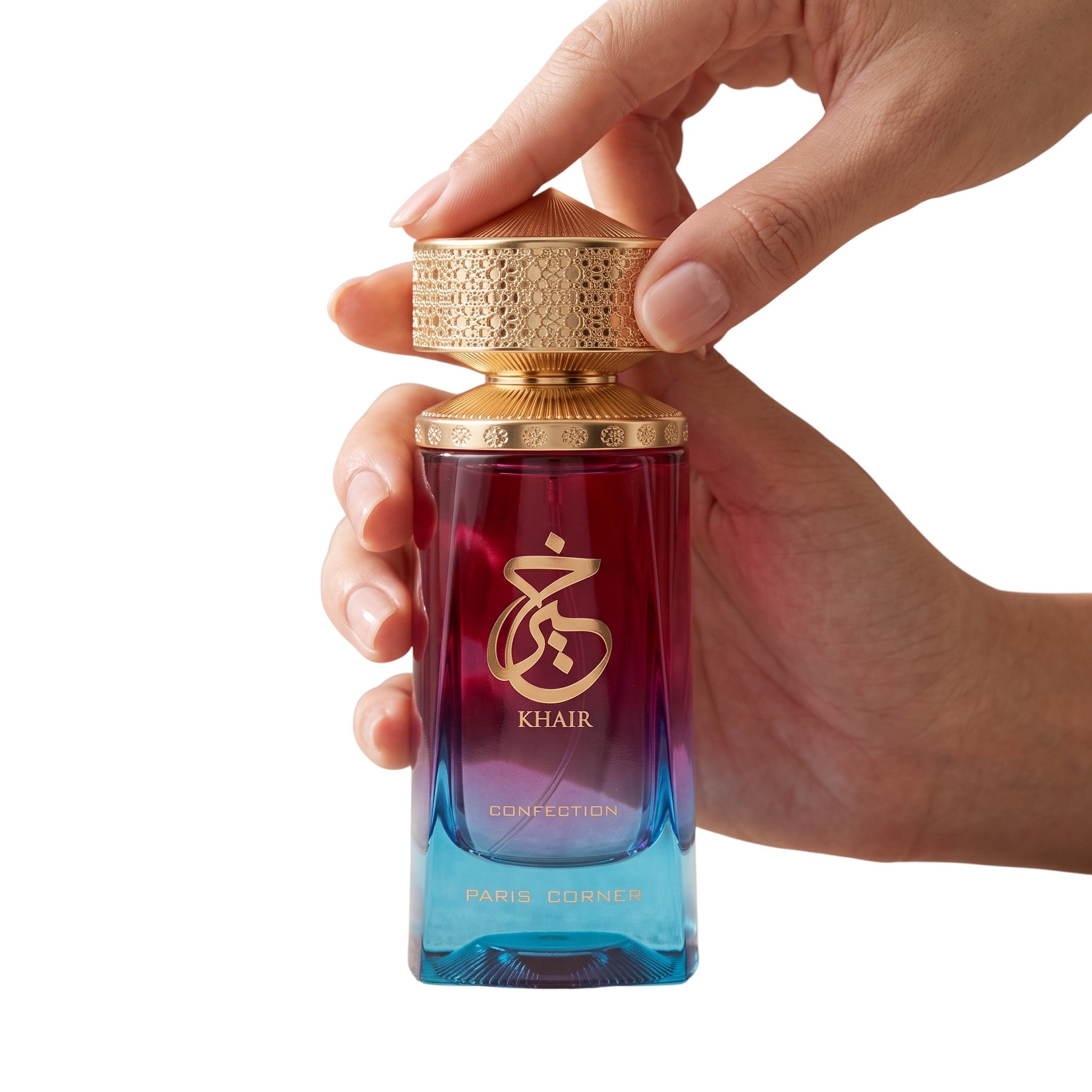 Palette 21 Khair Confection Eau de Parfum in a magenta to blue gradient glass bottle held by a hand