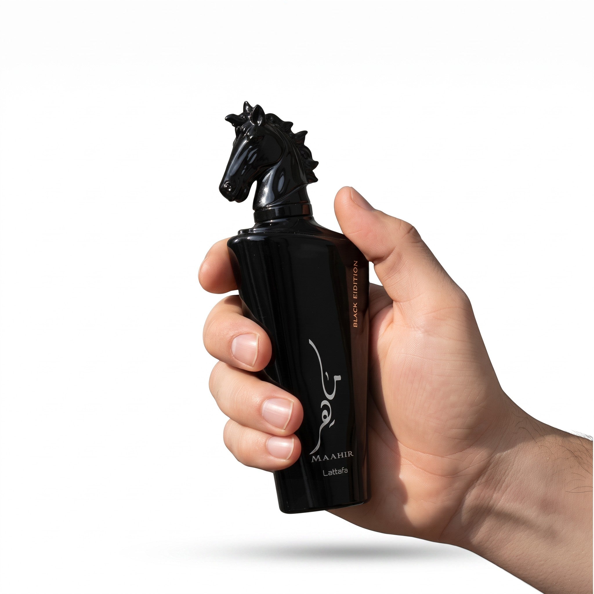 Palette 21 Lattafa Mahir Black Edition unisex perfume bottle with a signature horse head cap held in a hand.