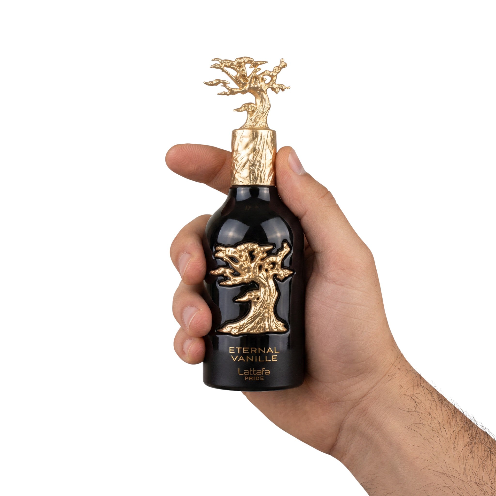 Palette 21 Lattafa Pride Eternal Vanille perfume bottle with gold tree emblem held in a hand against white background