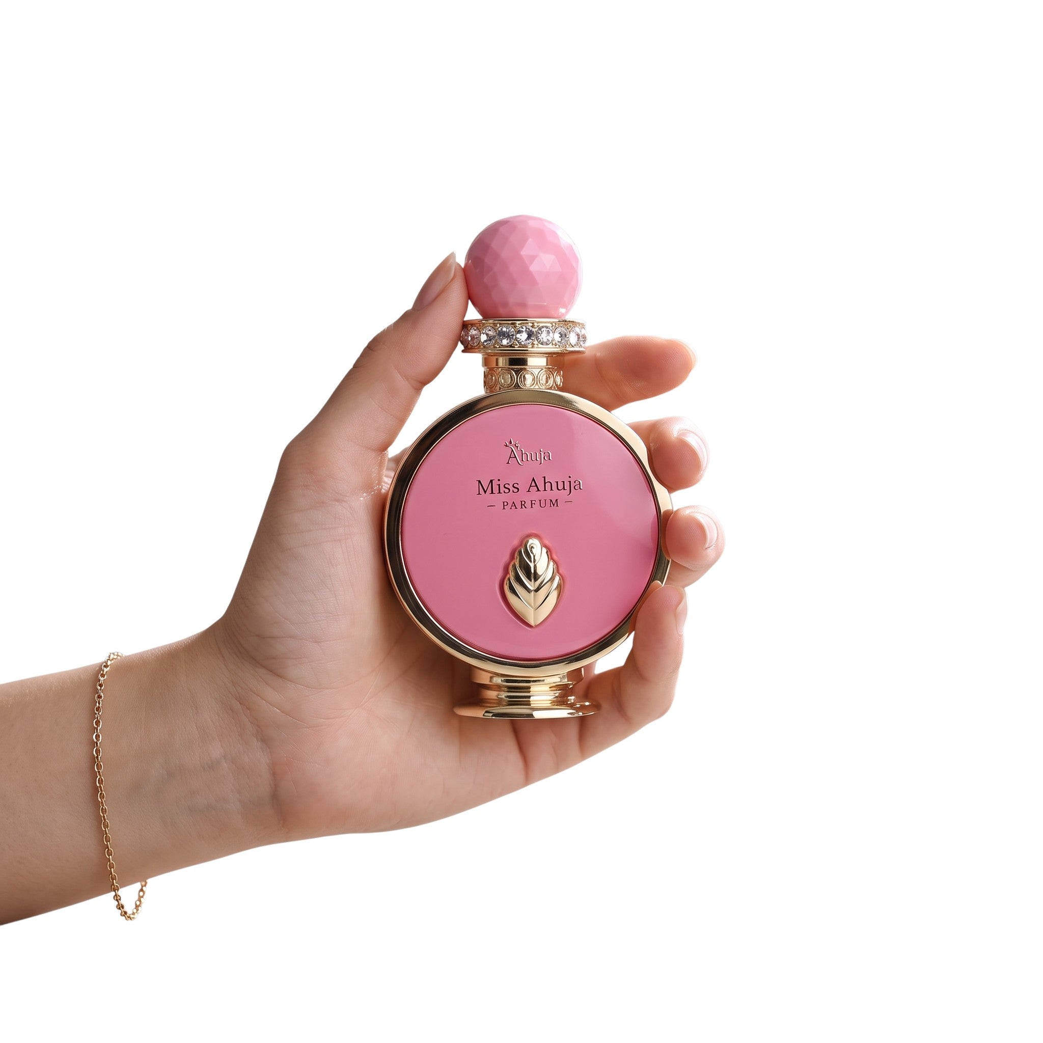 Palette 21 Miss Ahuja parfum bottle in pink with gold accents and crystal collar held in a woman's hand