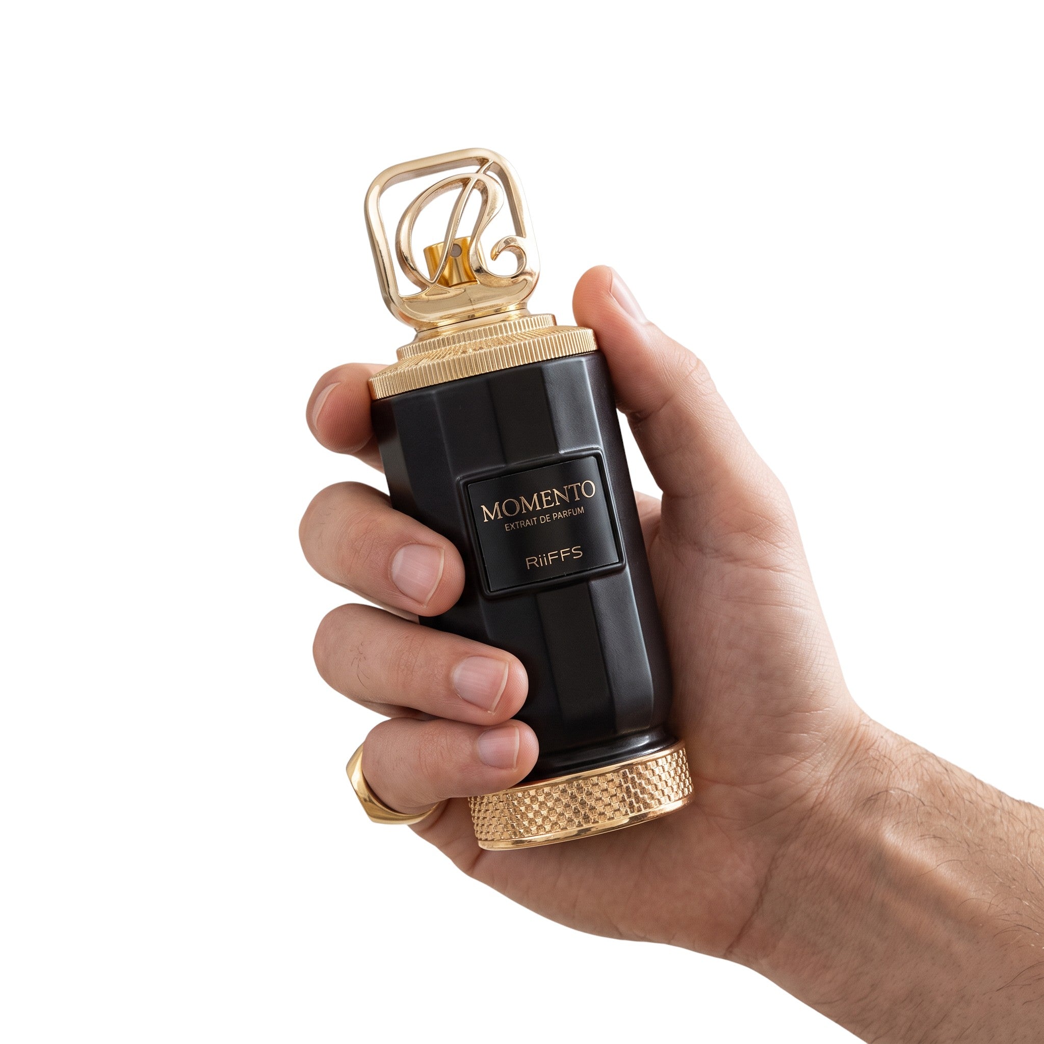Palette 21 Momento Riiffs Perfumes in a black and gold bottle held in a hand against a white background