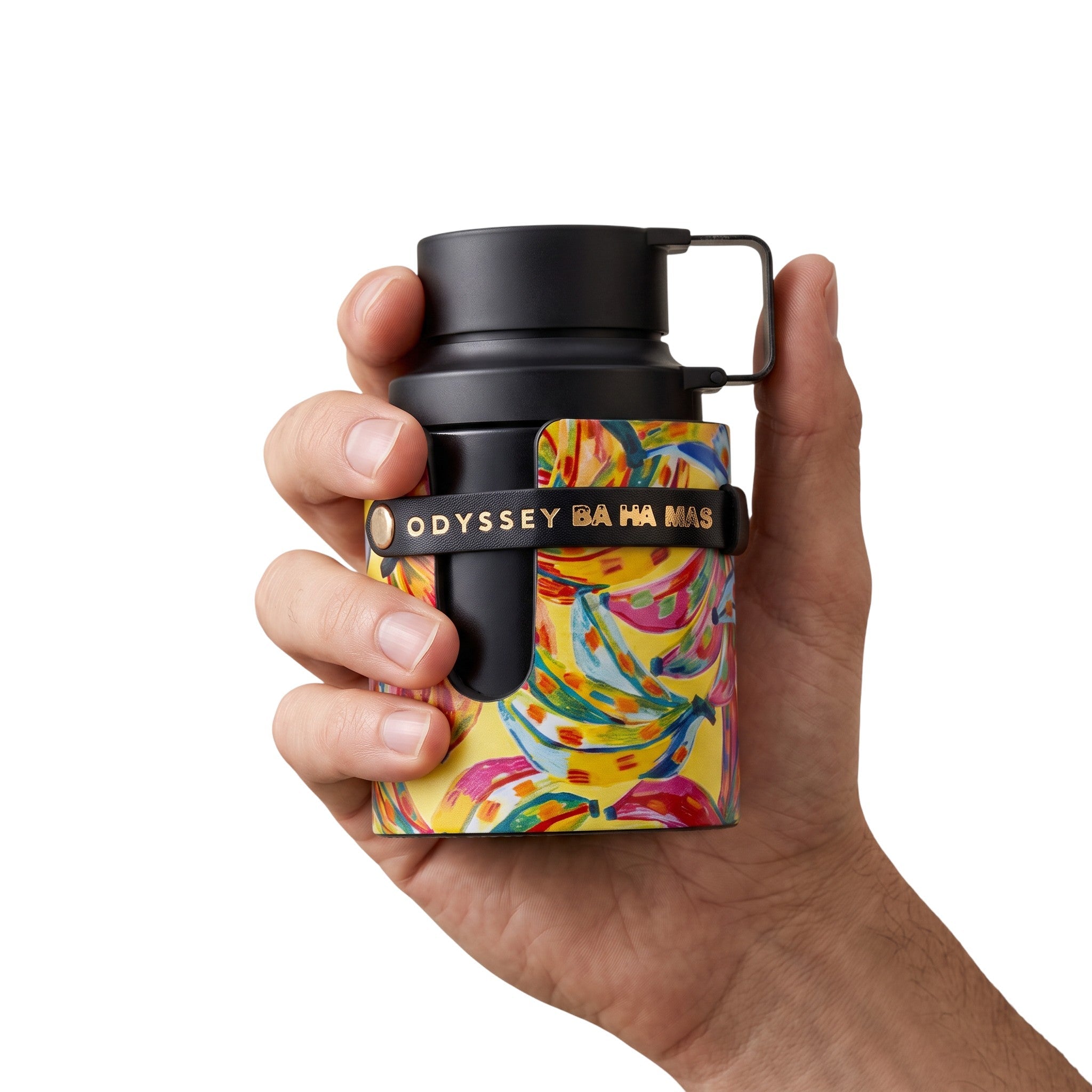 Palette 21 Armaf Odyssey BA HA MAS Eau de Parfum bottle with a vibrant tropical print held in a hand