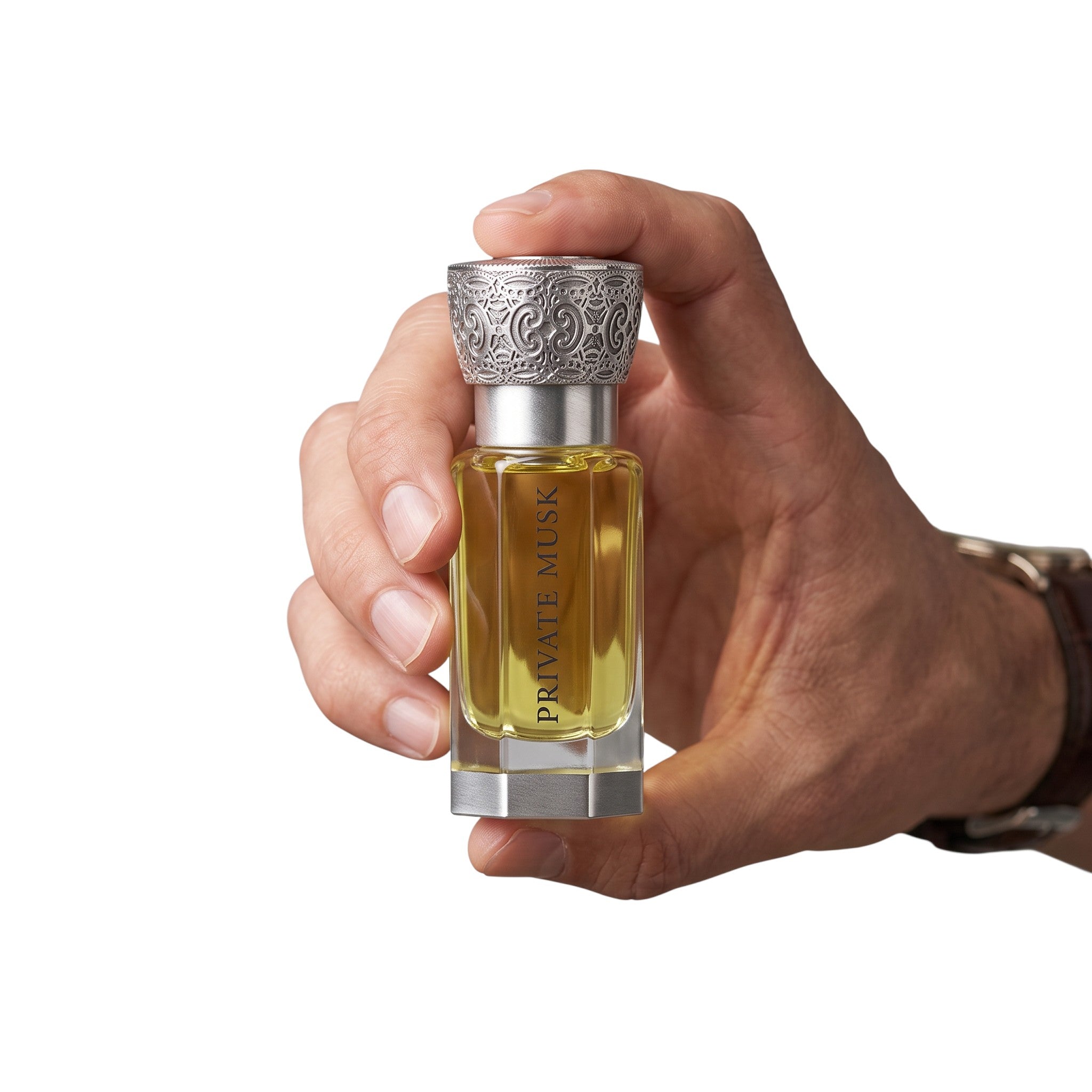 Palette 21 Private Musk Swiss Arabian perfume bottle held in hand featuring an ornate silver cap and golden fragrance