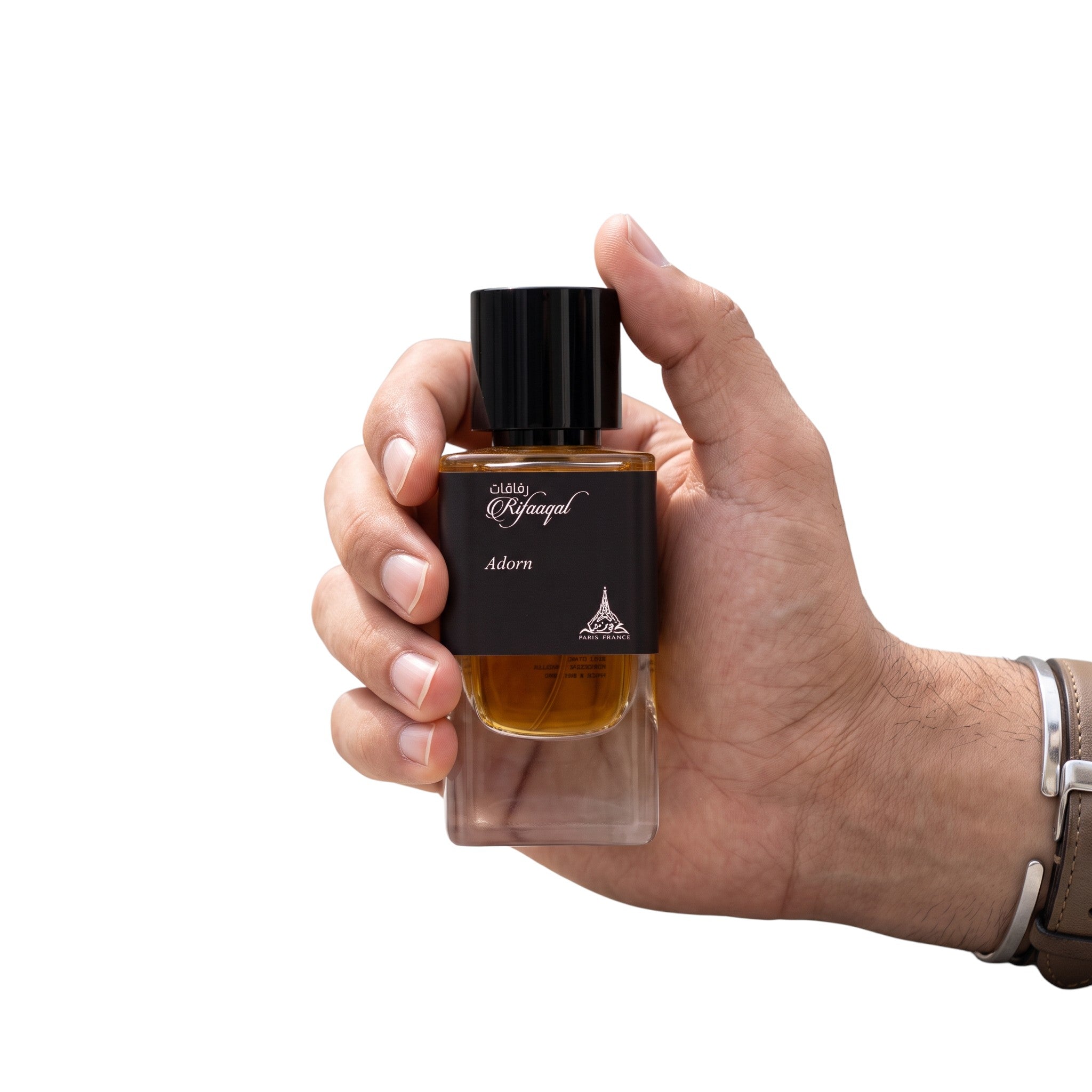 Palette 21 Paris Corner Rifaaqat Adorn eau de parfum in a minimalist glass bottle held in a hand