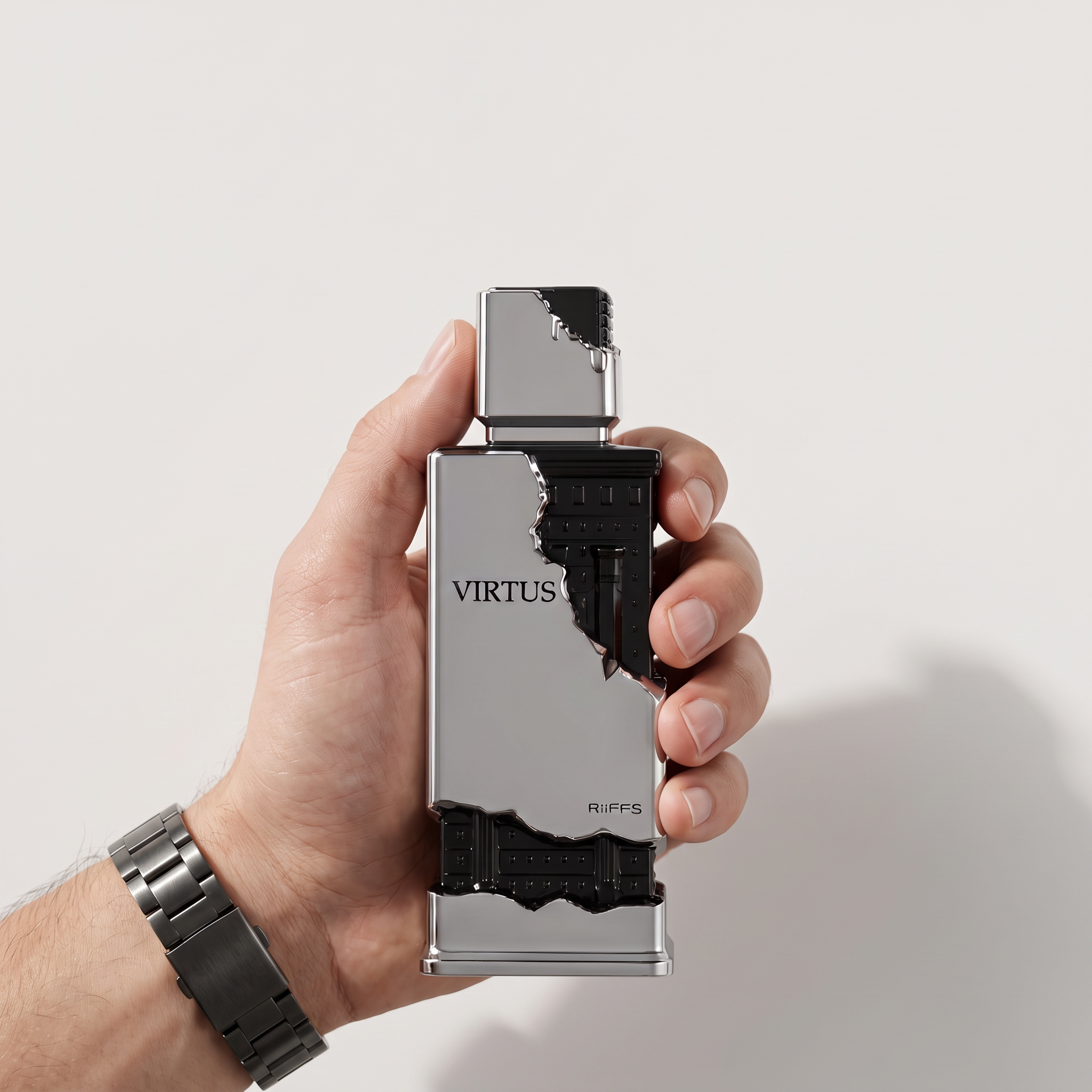 Palette 21 RIIFFS Virtus Extrait de Parfum held in a hand, featuring a silver and black architectural bottle design.