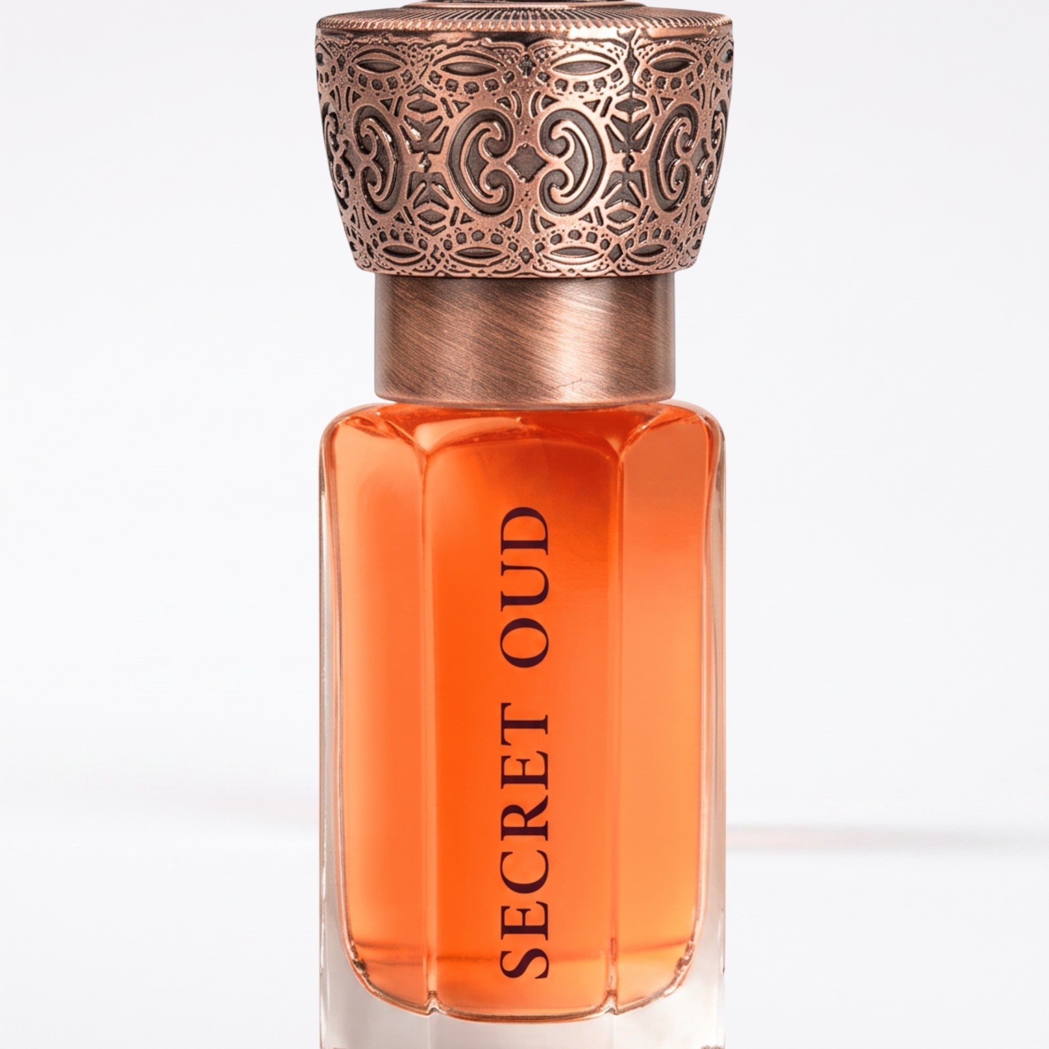 Palette 21 SWISS ARABIAN Secret Oud perfume oil in a glass bottle with an ornate metallic cap on a white background.