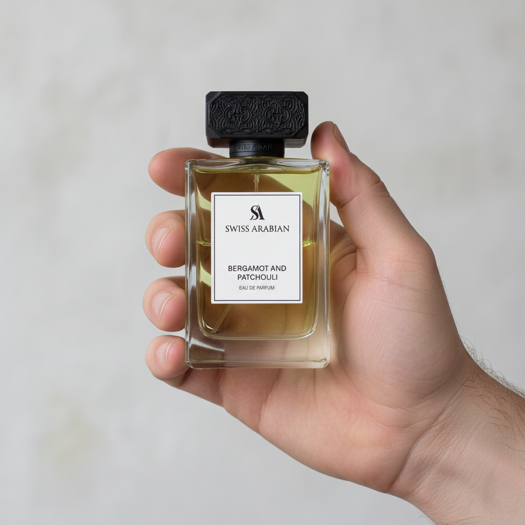 Palette 21 Swiss Arabian Bergamot and Patchouli perfume bottle held in a hand, featuring a sleek glass design.