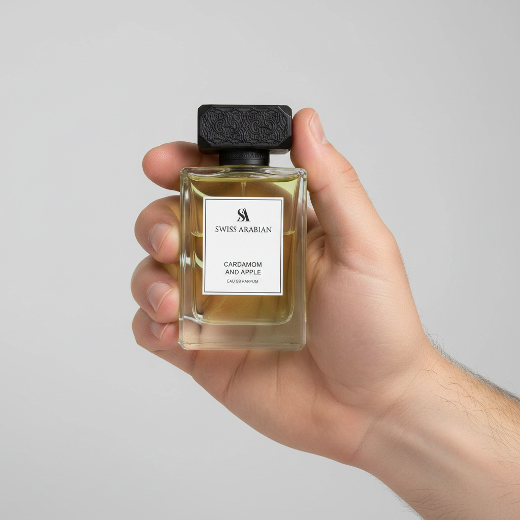 Palette 21 Swiss Arabian Cardamom and Apple Eau de Parfum in a clear glass bottle with a black cap held in a hand.