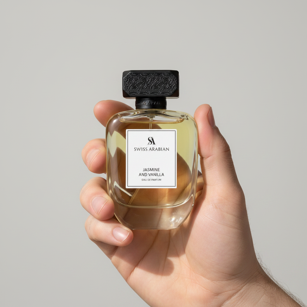 Palette 21 hand holding a glass bottle of Swiss Arabian Jasmine and Vanilla Eau de Parfum with a textured black cap.