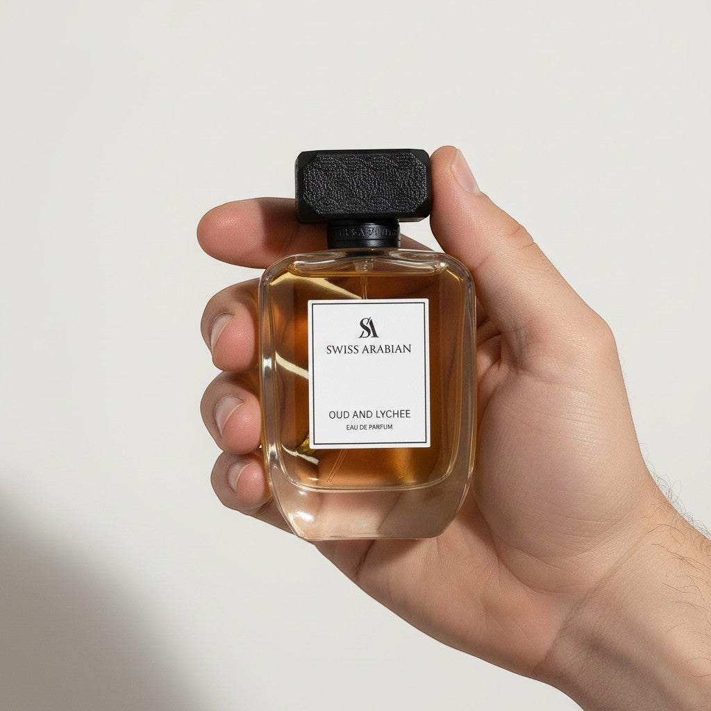 Palette 21 Swiss Arabian Oud and Lychee Eau de Parfum in a glass bottle with a black cap held in a hand