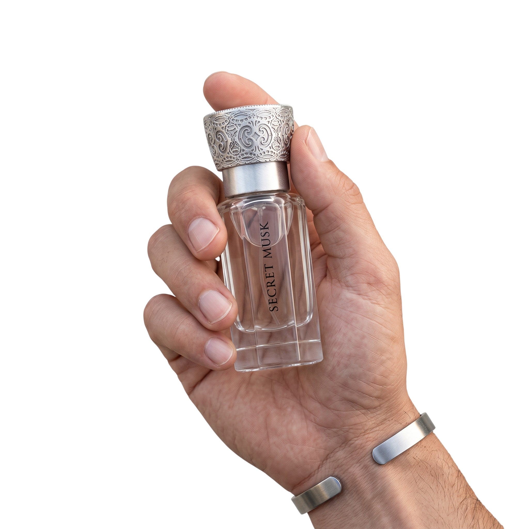 Palette 21 SWISS ARABIAN Secret Musk perfume oil in a clear glass bottle with an ornate silver cap held in a hand