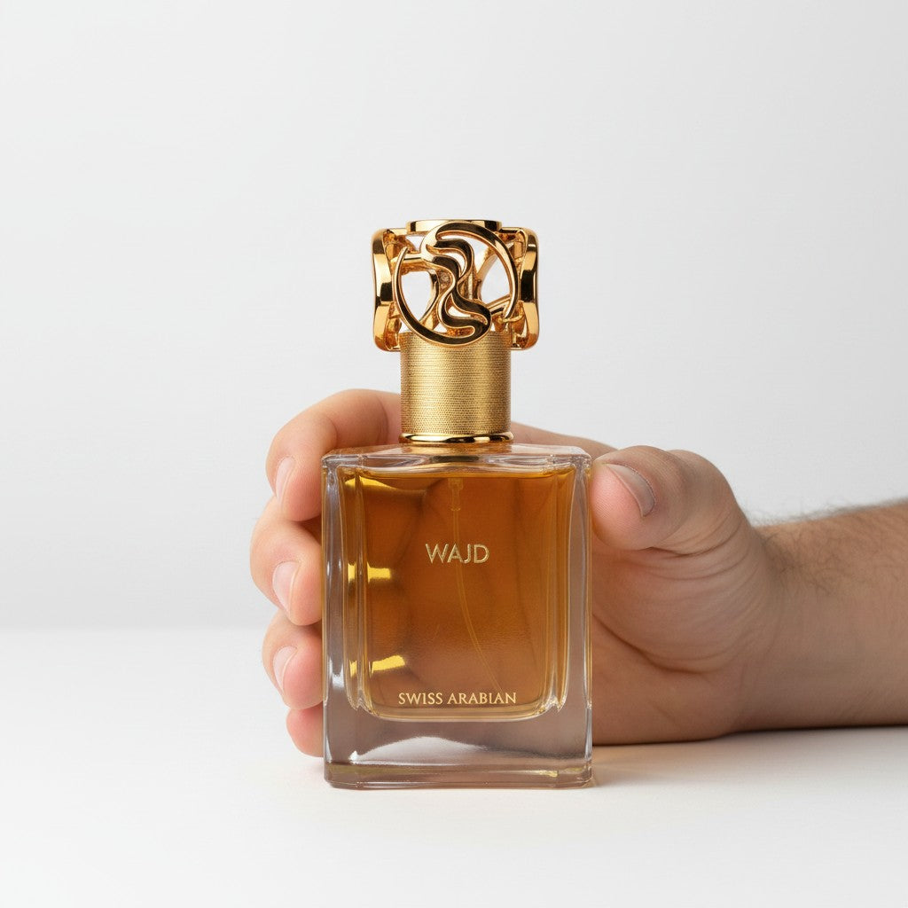 Palette 21 WAJD Swiss Arabian perfume in a rectangular glass bottle with an ornate gold cap held in a hand